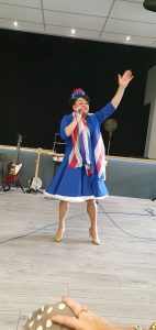 Forces’ entertainer Annie Riley singing the Queen's favourite songs to North West Veterans