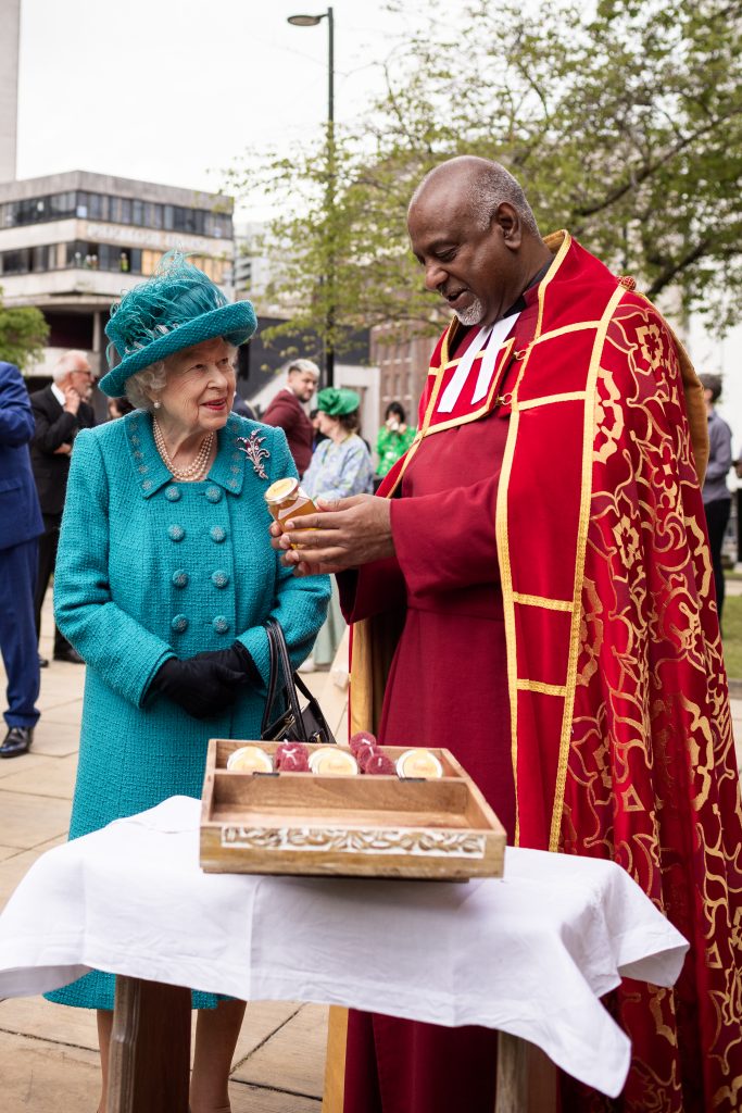 Queen Elizabeth II is presented with a pot of Cathedral Honey on a visit to Manchester Cathedral in 2021