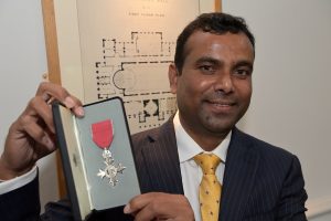Dr Kondal Reddy Kandadi holding his Honorary MBE