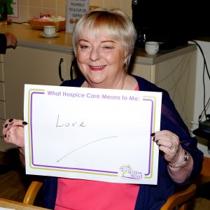 Mrs Sharman Birtles, the Vice Lord-Lieutenant holding a note about what Hospice Care Means to her. It reads Love.