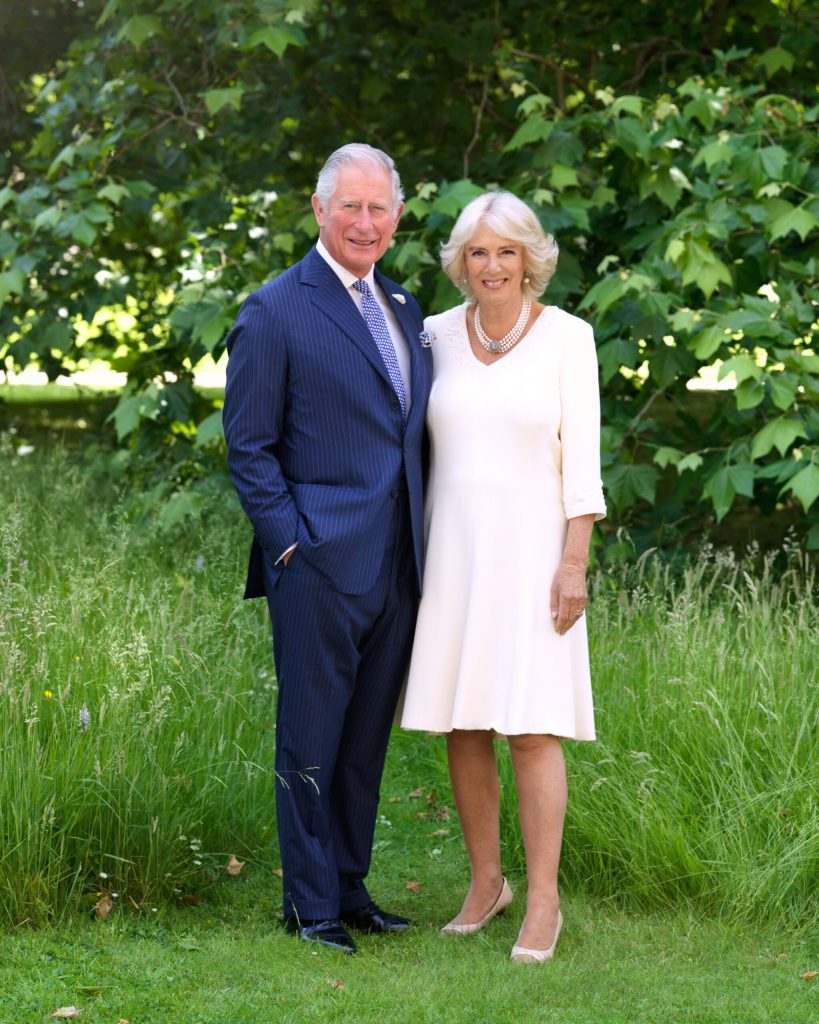 Photograph of The King and Queen Consort in a country setting