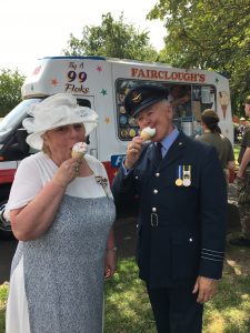 Roy and the Vice Lord-Lieutenant eating an ice cream during Armed Forces Day in front of an ice cream van where army cadets are queuing
