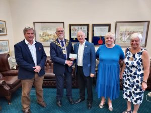 Roy presents a cheque to the Mayor of Tameside for his charities from the Duchy of Lancaster Benevolent Fund. He is joined by members of the Lieutenancy District Committee
