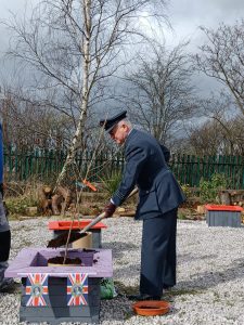 Roy, in uniform plants a tree, on behalf of the Lord-Lieutenant, as part of The Queen's Green Canopy.